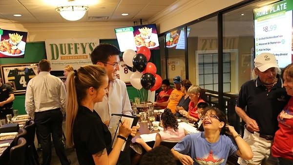 Jason Emmett, president of Duffy’s Sports Grill, meets Special Olympics athletes at the Duffy's Foundation's Athlete Celebration Dinner. (Submitted photo)